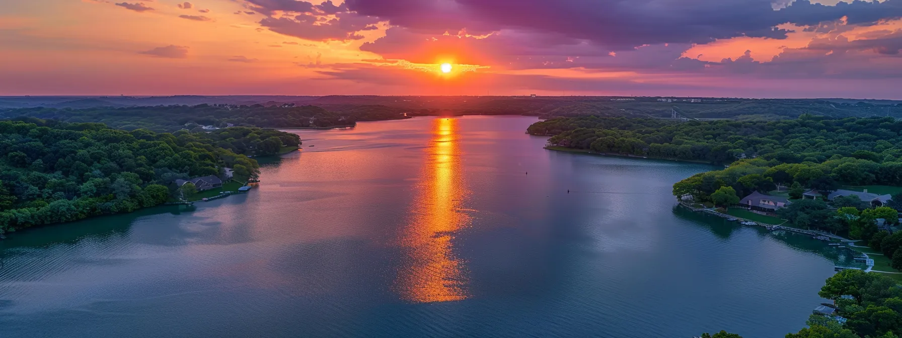 a breathtaking sunset descends over a tranquil lake, its vibrant orange and purple hues reflecting perfectly on the water's surface, surrounded by lush evergreen forests.