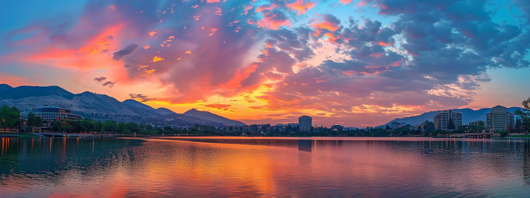 a radiant sunset paints the sky in vibrant hues of orange and pink, casting a warm glow over a tranquil lake reflecting the fiery colors above.